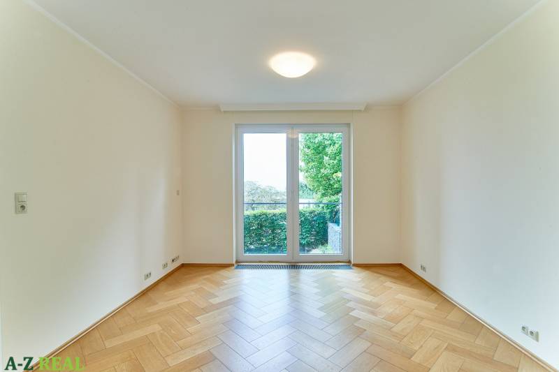 A room with a wooden floor decor and a large window in a 3-room apartment.