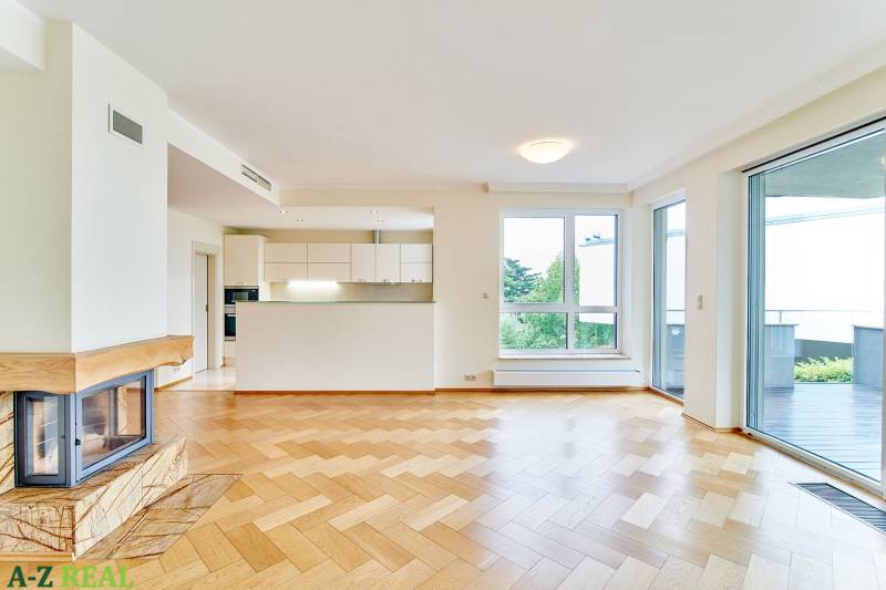 Living room with wood-patterned flooring, fireplace, kitchen, and large windows in a 3-room apartment.