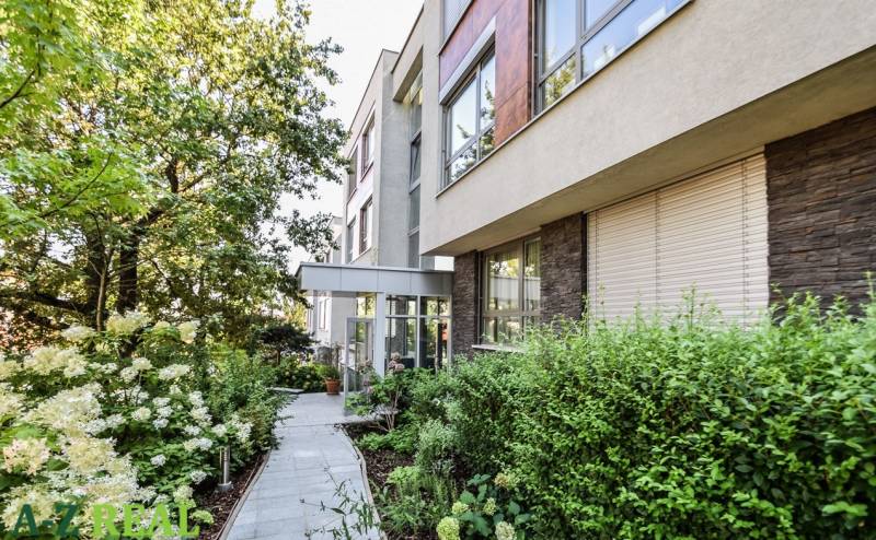 An apartment building on Mudroňova Street in Bratislava - Old Town, surrounded by greenery and a garden.