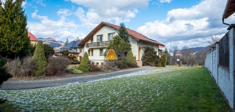 A villa in Žarnovica on Andrej Sládkovič Street surrounded by greenery and mountains.