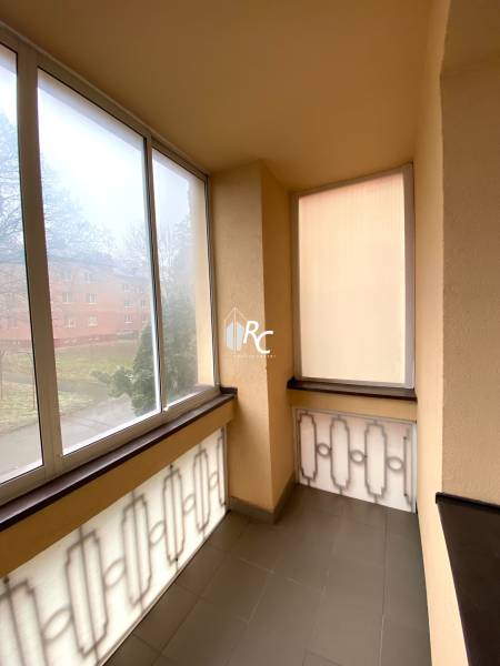 A glazed balcony in a 2-room apartment with a view of the surroundings.