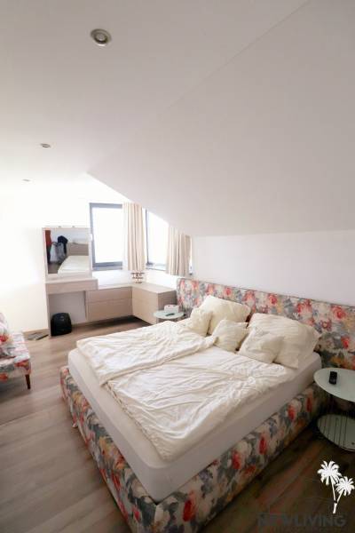 On Jánošíkova Street, in a family house, there is a cozy bedroom with a bed and decorative curtains.