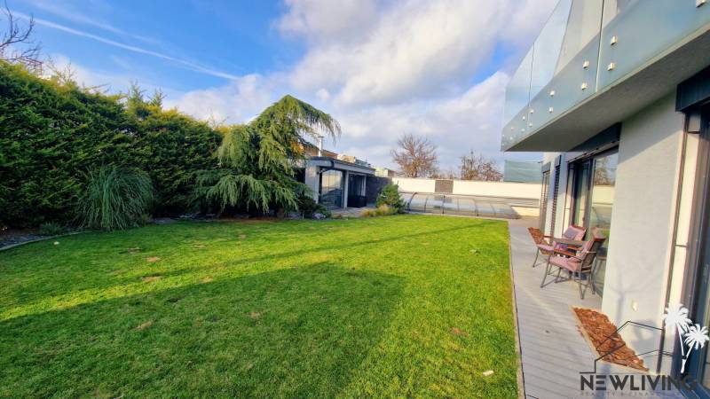 Garden space of a family house on Jánošíkova Street in Piešťany with a terrace and garden seating.