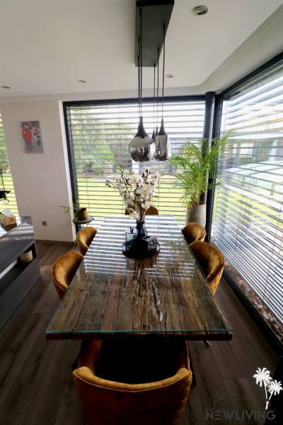 Dining table with flowers, wooden decor floor, family house.