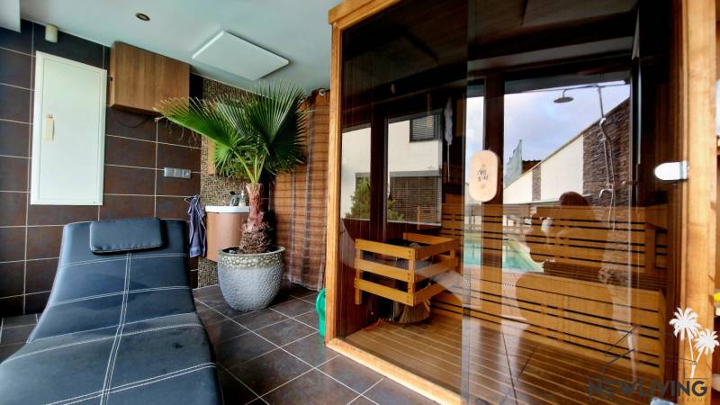 Room with a black lounger, sauna, and palm tree, on Jánošíkova Street and Family house.