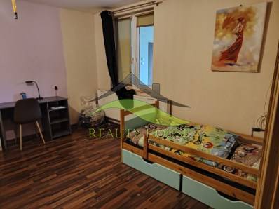 Children's room in a family house with a wooden decor floor and a work corner.