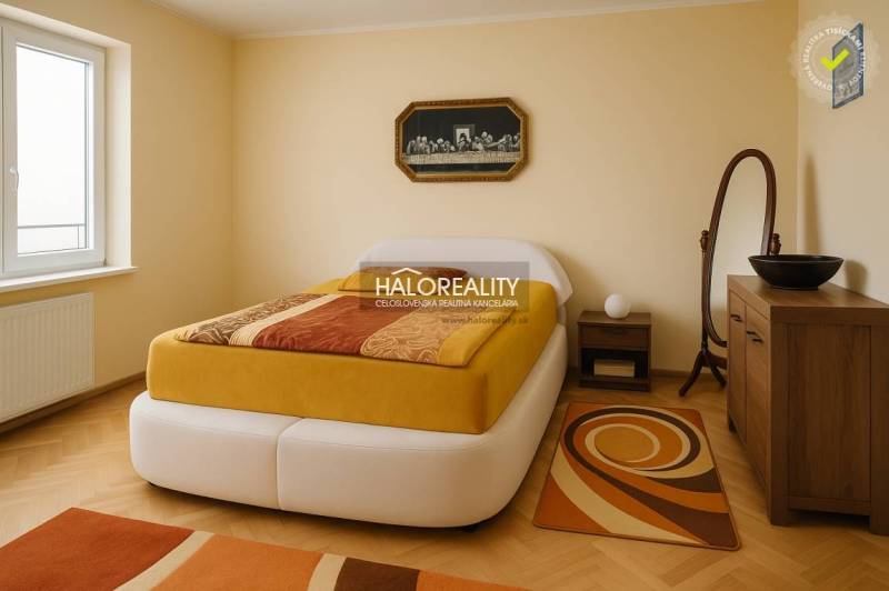 Bedroom with wood-patterned flooring in a family house, light walls, modern furnishings.