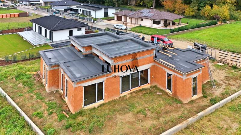A family house under construction on Medová Street in Lednické Rovne, surrounded by a green lawn.