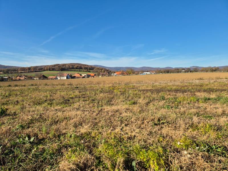 Plots - living in Velčice with a view of the hills and village buildings.