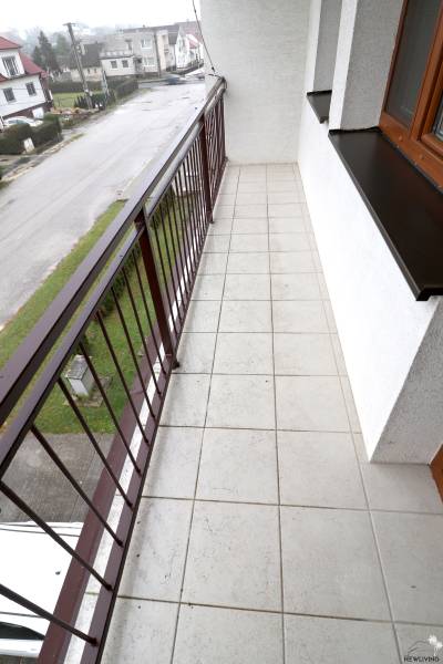 A balcony in a family house on Dolný Lopašov Street in Dolný Lopašov with tiles and a railing.