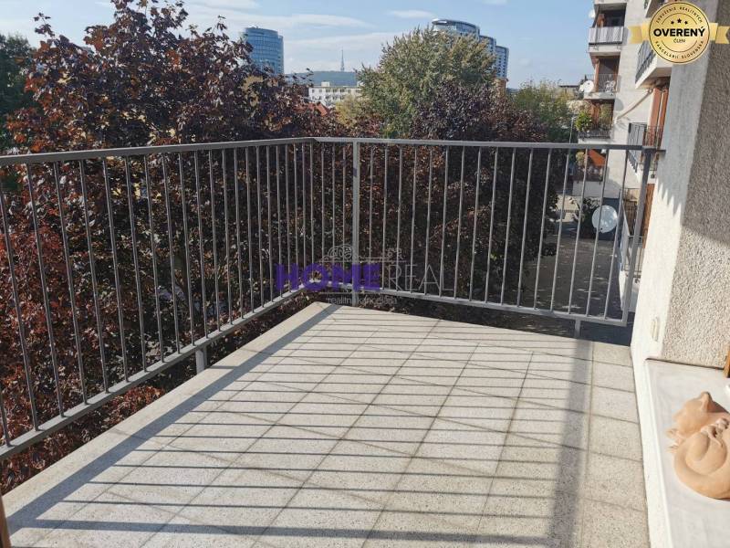 The balcony of a 2-room apartment on Drieňová Street in Bratislava - Ružinov with greenery in the background.
