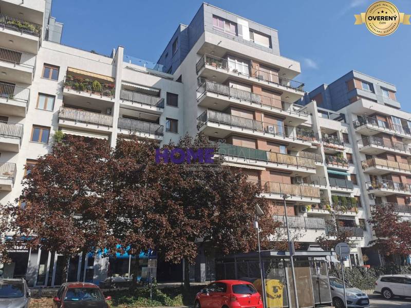 Apartment building with greenery on Drieňová Street, Bratislava - Ružinov, parking spaces in the front.