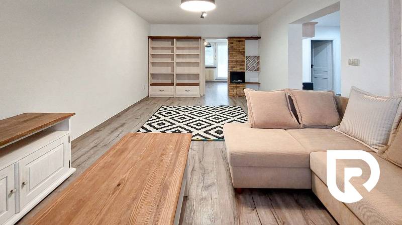 Living room in a 3-room apartment with a sofa and a wooden decor floor.