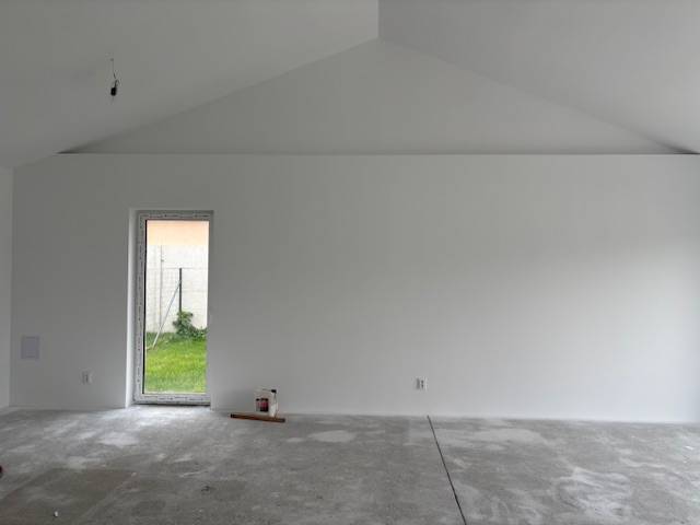 White wall and concrete floor in a family house, ready for interior finishing.