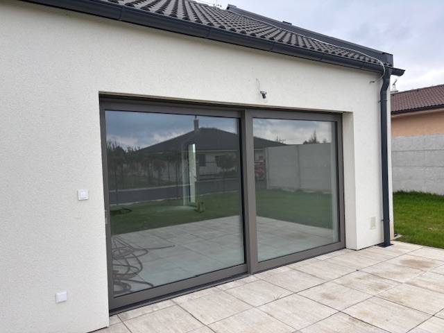 A family house in Tomášov on Fialková Street with sliding doors and a terrace.