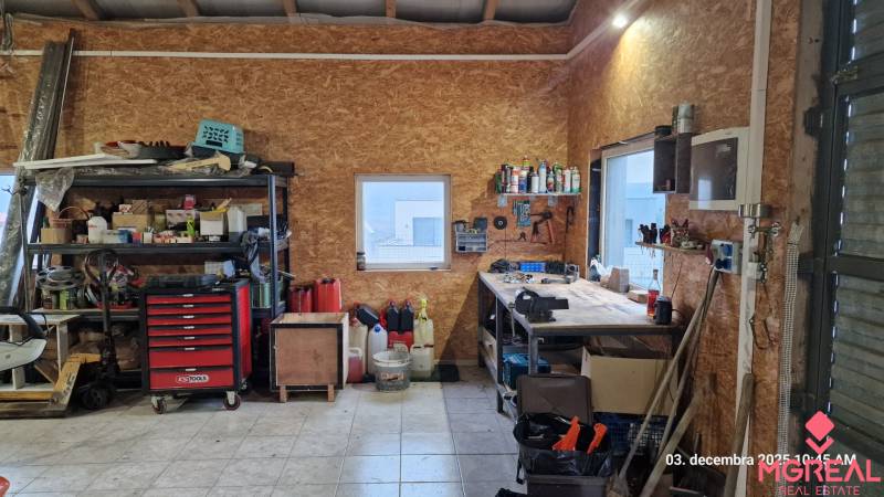 Workshop with tools and storage in a family house with wooden decor flooring.