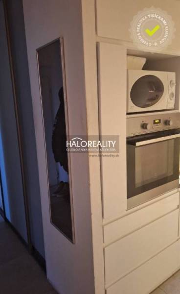 Interior of a 3-room apartment with a wooden decor floor and a white dresser.