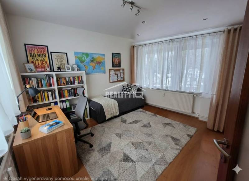 A study in a 4-room apartment with a wooden decor floor, a bookshelf, and a desk.