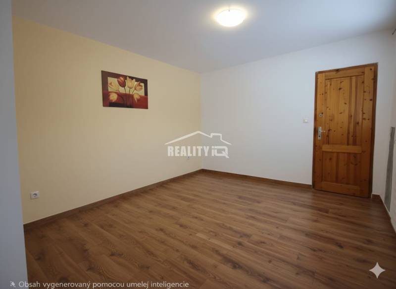 A room with a wooden floor, a painting on the wall, and wooden doors.