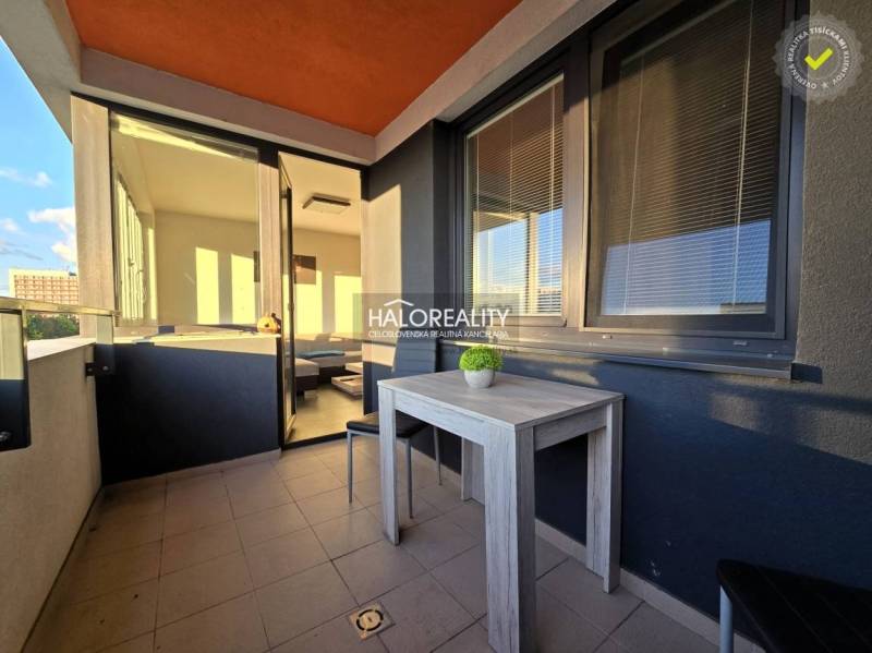 Balcony of a 2-room apartment in Trnava with a view and a table on the terrace.