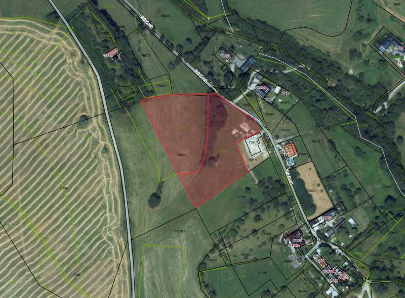 Aerial map of agricultural and forest lands around Banská Štiavnica.