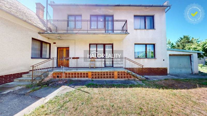 A family house in Malacky with a balcony and a garage, surrounded by a garden.