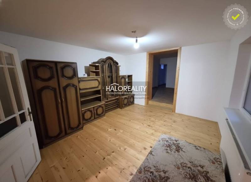 A room with a wooden decor floor, antique furniture, family house.