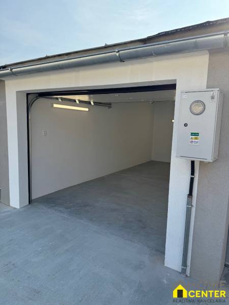 Garage with an opening on Slnečná Street in Komárno with a concrete floor and an electrical installation box.