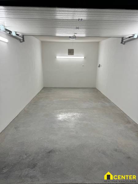 A spacious garage with white walls and a concrete floor in the Garage on Slnečná, Komárno.