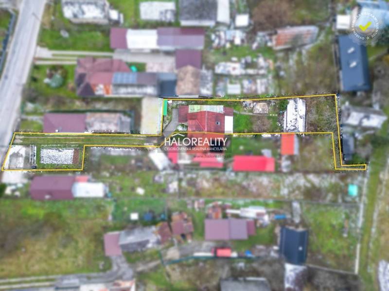 Aerial view of a family house in Brvnište with a large fenced garden.