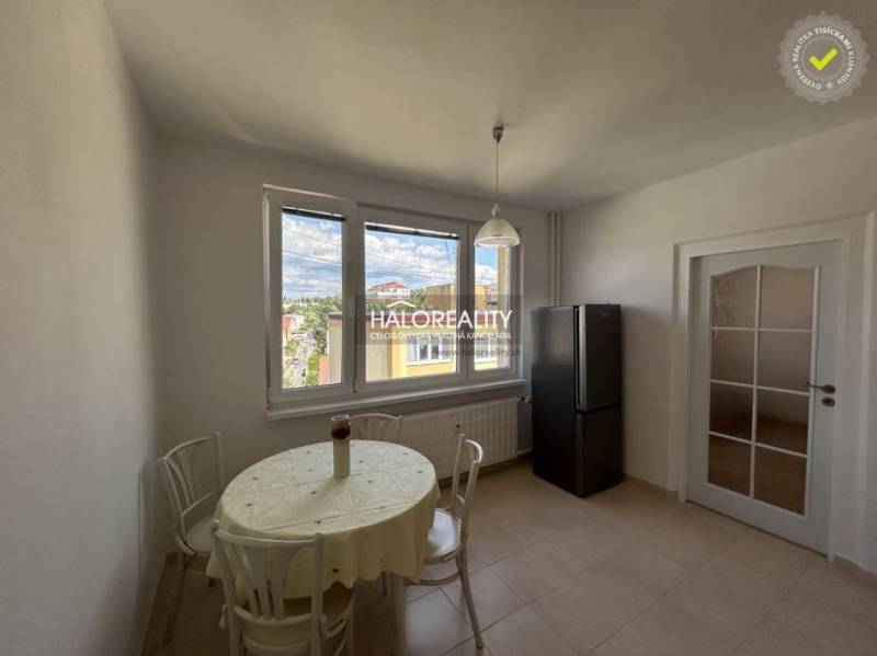 Dining area with a window, table, and chairs in a studio apartment.
