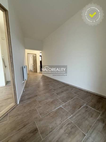 Interior of a family house with a wooden decor floor and white walls.