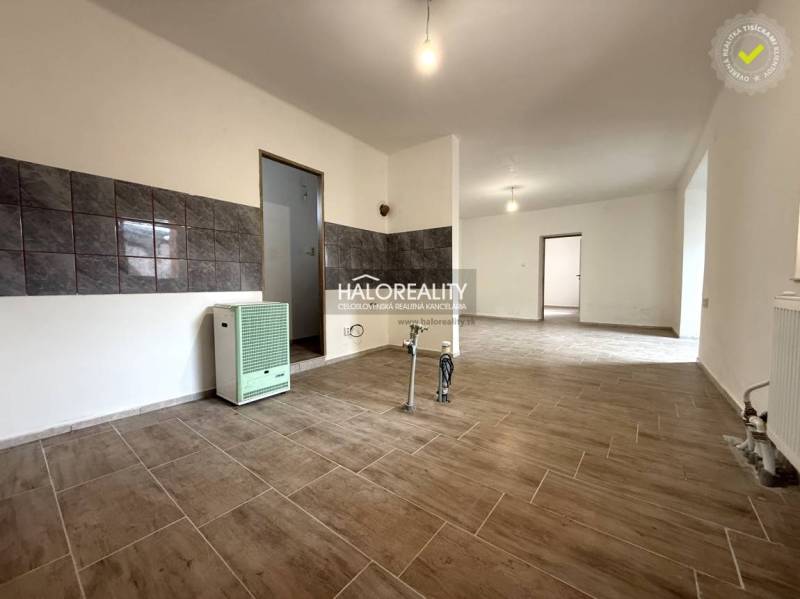 Interior of a family house with a wooden decor floor and tiles on the wall.