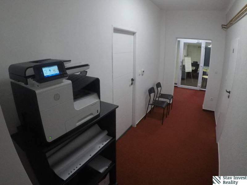 A corridor with a printer and chairs, entrance to the office on Šamorínska in Senec.