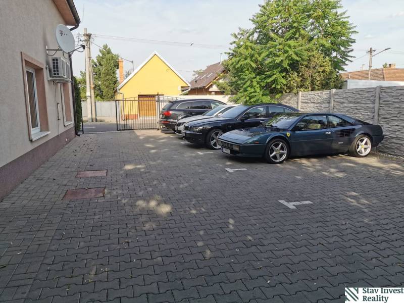 Parking lot on Šamorínska Street in Senec next to the offices, with cars including a sports car.