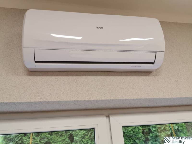 Air conditioning installed on the wall above the window in the office.