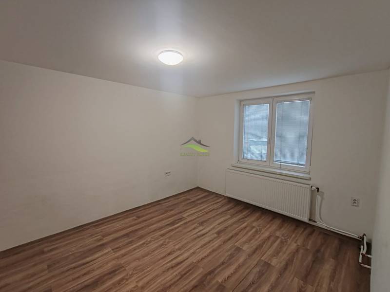 An empty room with a wooden floor, part of a 3-room apartment.