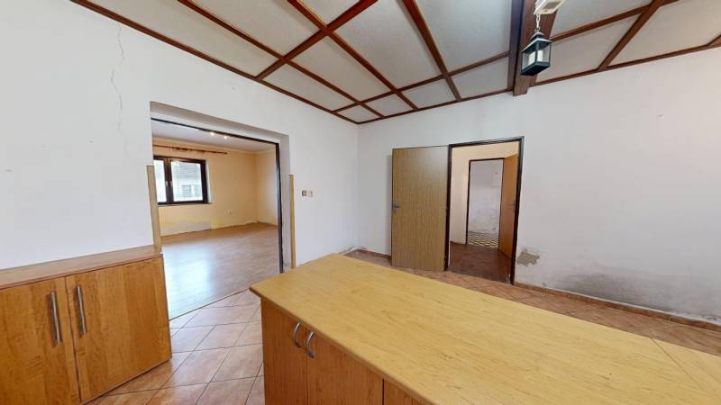 Interior of a family house with wooden floor decor and light-colored walls.