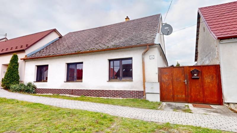 A family house on SNP Street in Veľké Leváre, with a white facade and a gabled roof.