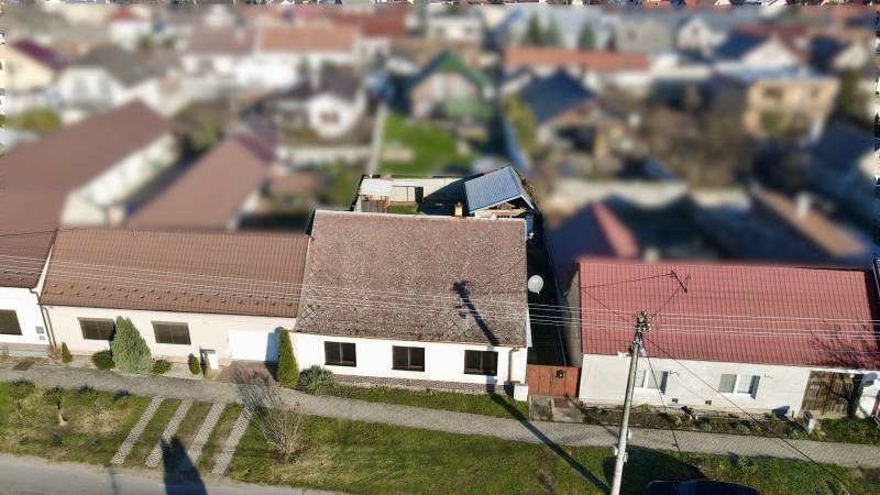 A family house on SNP Street in Veľké Leváre with a front garden and a sloped roof.