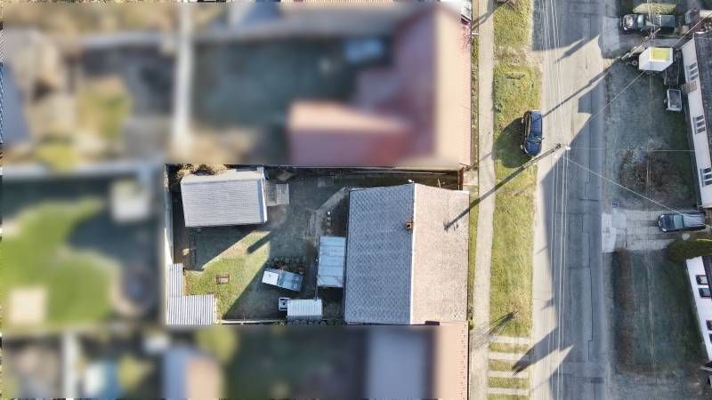 Aerial view of the roofs and gardens of family houses on SNP Street in Veľké Leváre.