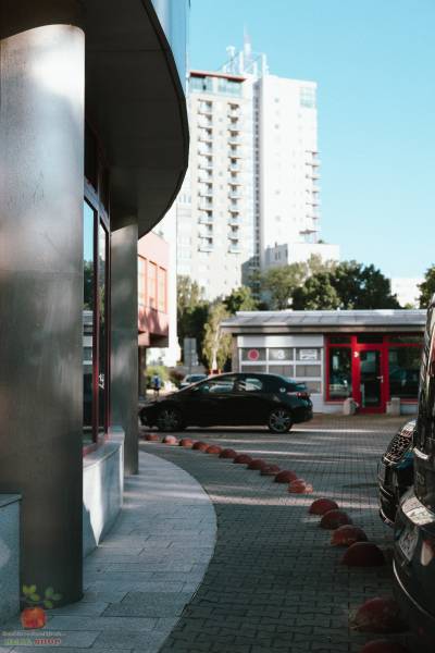 Záhradnícka Street in Bratislava with high-rise buildings and a parked car.