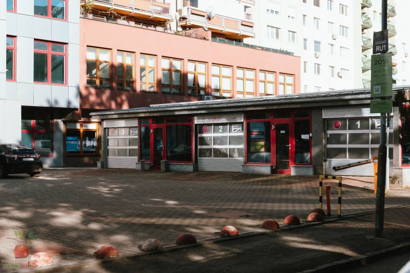 Building with garages and parking lot on Záhradnícka Street in Bratislava.