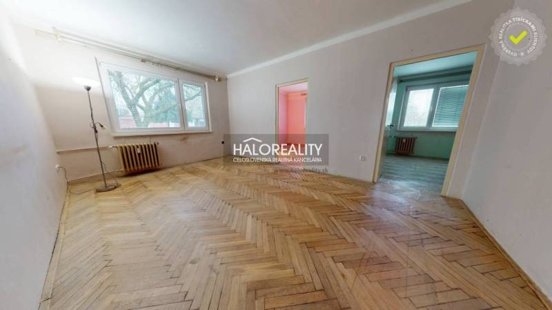 The interior of a 3-room apartment with a wooden decor floor and light-colored walls.