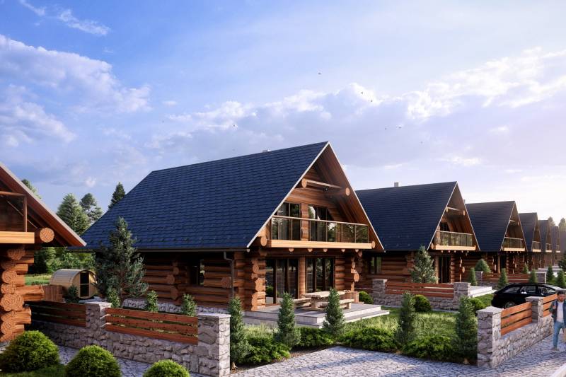 Construction of houses in Nová Lesná with wooden elements and stone fences.