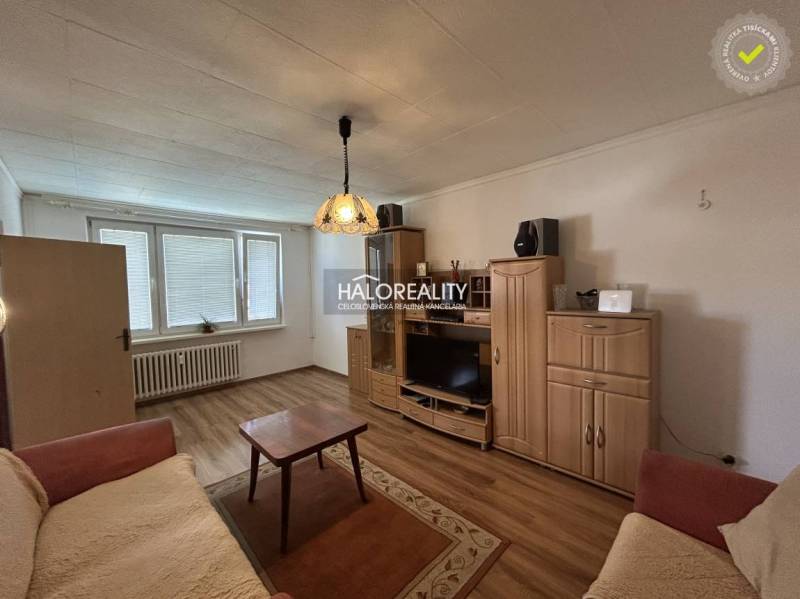 Living room with wood-patterned flooring in a 2-room apartment, cozy furnishings.
