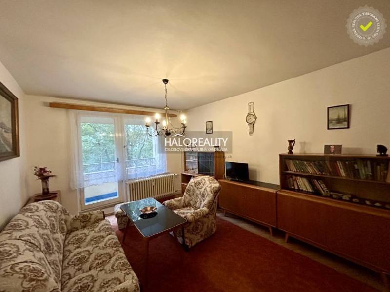 Living room with antique furniture, sofa, and chandeliers in a 4-room apartment.