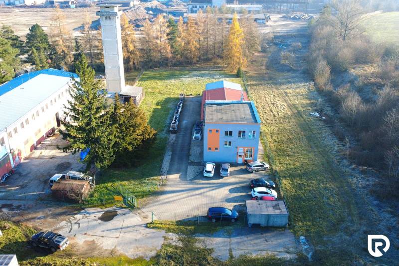 Production facilities on Továrenská Street in Dubnica nad Váhom with adjacent parking and greenery.