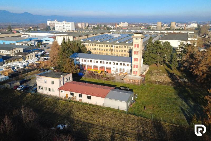 Production facilities on Továrenská Street in Dubnica nad Váhom, surrounded by greenery and buildings.