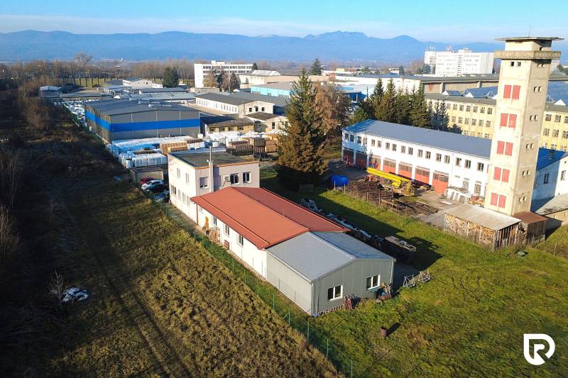 Production facilities on Továrenská Street in Dubnica nad Váhom, surrounded by extensive green areas.